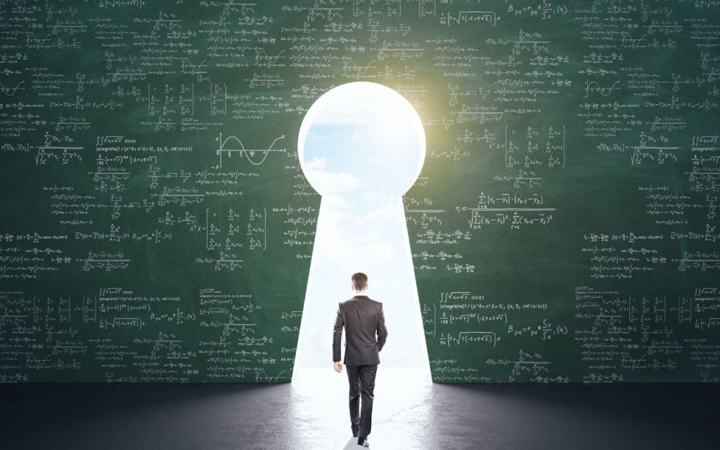 A man in a suit walks towards a bright light through a keyhole-shaped opening in a chalkboard covered with mathematical equations.