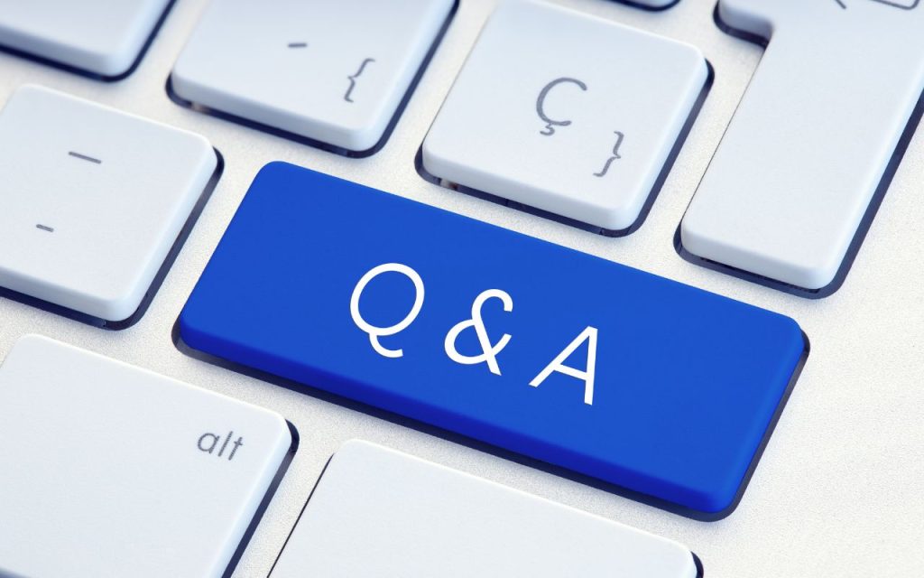 A computer keyboard with a large blue key labeled "Q & A" in white letters, replacing the usual Enter key.