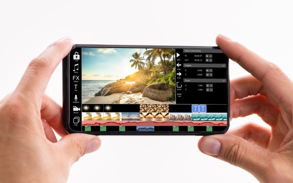 A person holds a smartphone displaying a video editing app with a tropical beach video and various editing tools on the screen.